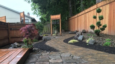 A stone tile walkway in a backyard Photo